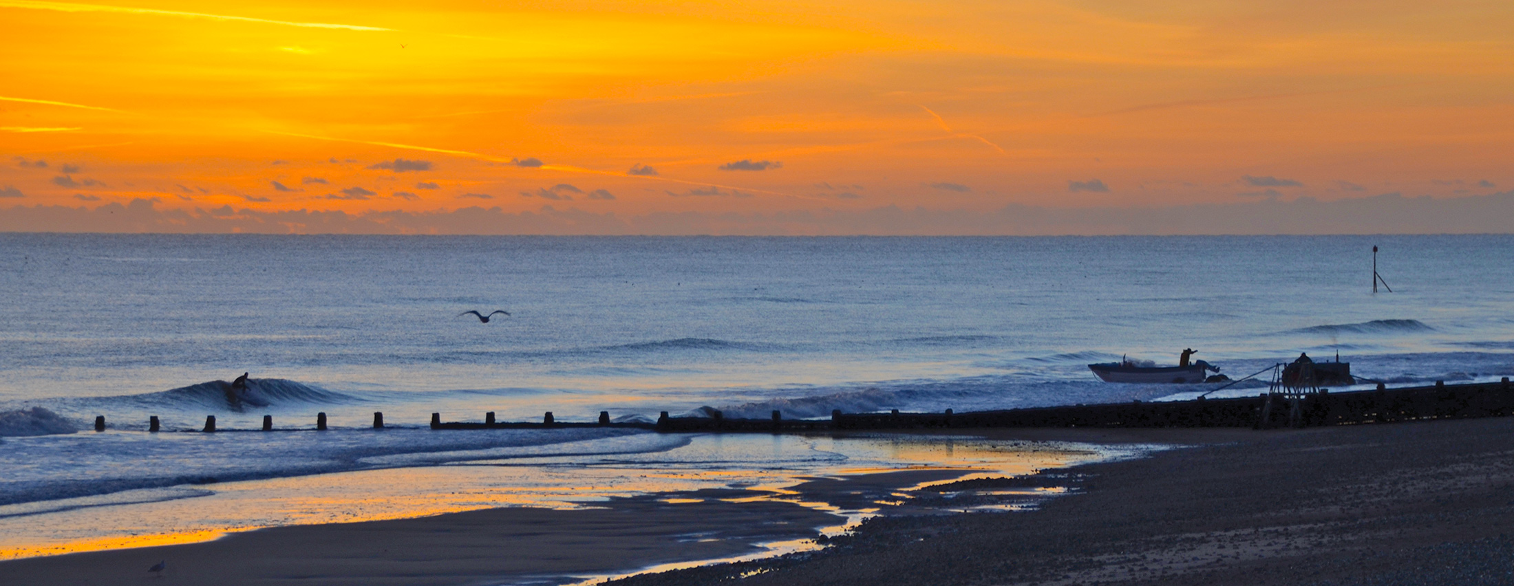 Surfer, Fisherman and Sunrise. Classic Norfolk Surfing.